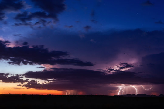 Thunderstorms with lightning at sunset