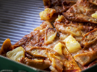 Close up of thin and crispy Pizza in a delivery cardboard box