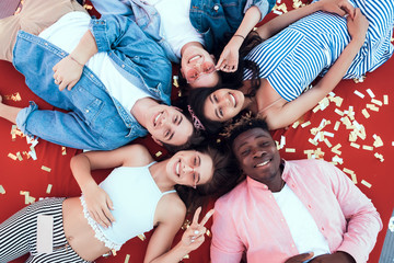 Top view portrait of beaming ladies and happy males relaxing after good party on comfortable couch....