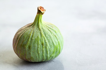 green figs on a gray stone background, concept, copy space