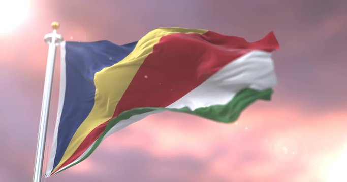 Seychelles flag waving at wind in slow at sunset, loop