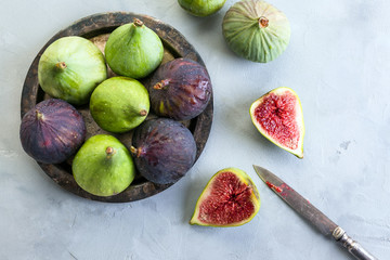 green and blue figs on a metal plate and gray stone background