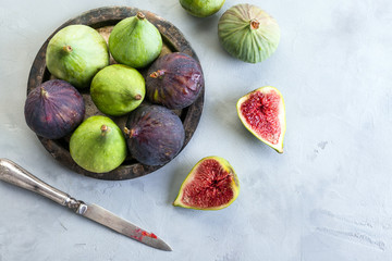 green and blue figs on a metal plate and gray stone background