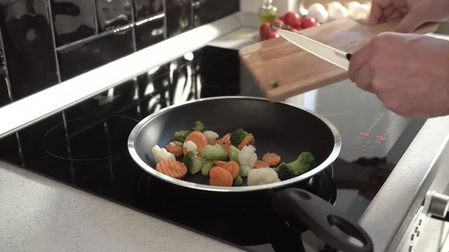 Cooking Vegetables On Frying Pan At Home Kitchen Closeup