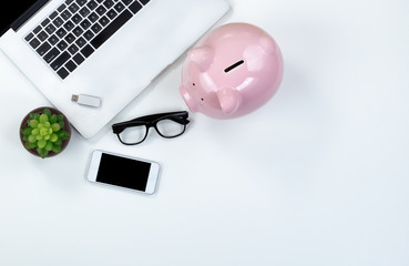 White desktop with piggy bank for finance concept