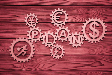 office worker, plan, dollar notes, euro, gears on a wooden background. business planning. finance. currency.