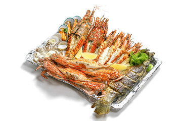 Grilled Mixed Seafoods Jumbo Set contain Lobsters, Clams, Fish, Blue Clabs, Big Shrimps, Mussels and Calamari Squids with pieces of lemon & vetgetables isolated on white background with shadow.