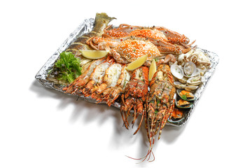 Grilled Mixed Seafoods Jumbo Set contain Lobsters, Clams, Fish, Blue Clabs, Big Shrimps, Mussels and Calamari Squids with pieces of lemon & vetgetables isolated on white background with shadow.