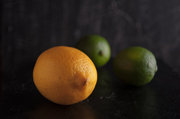 Fototapeta na wymiar Lemon, lime on a black background.