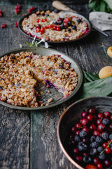 delicious pies with berries on wooden table