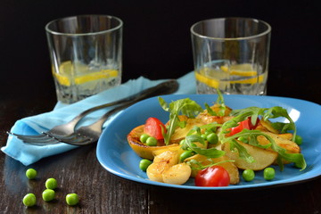 Baked potatoes, garlic, green peas, arugula and lemon, salad