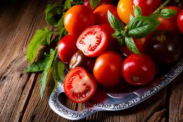 various types of tomatoes served and presented on the silver platter.