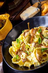 Reginette noodles in cream sauce with fresh chanterelles and capers