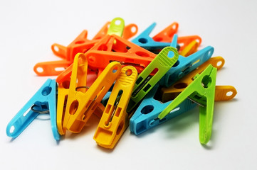 clothespins of color: yellow, orange, blue, green, lying in a heap at close distance