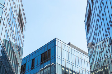 Obraz na płótnie Canvas Glass facade of the buildings with a blue sky.