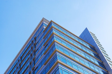 Fototapeta na wymiar Glass facade of the building with a blue sky.