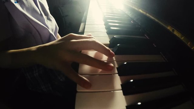 Asian little girl practicing piano