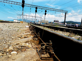 railroad tracks taken from a low angle, with houses in the background