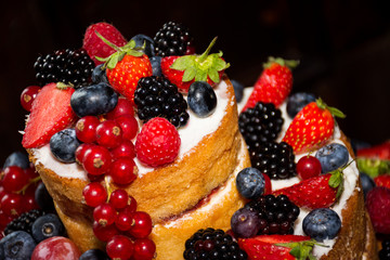 Multi tiered sponge and cream wedding cake decorated with fruit