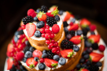 Multi tiered sponge and cream wedding cake decorated with fruit