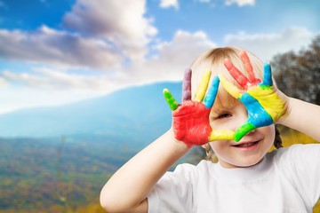 Little girl with hands in paint