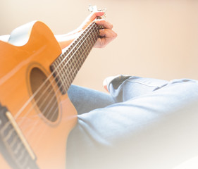 The left hand man is holding a chord on a guitar classical