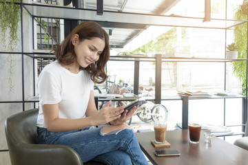 Beautiful business girl working with tablet , smartphone and drinking coffee in coffee shop