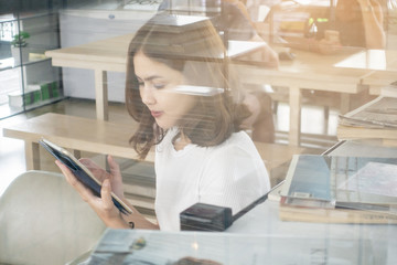 Beautiful business girl working with tablet , smartphone and drinking coffee in coffee shop