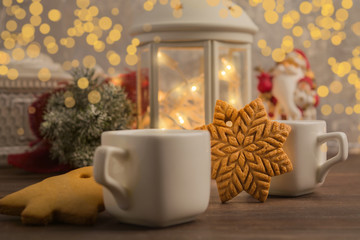 Fototapeta na wymiar Cozy winter at home with hot drink and cookies. Christmas time with tea and garland