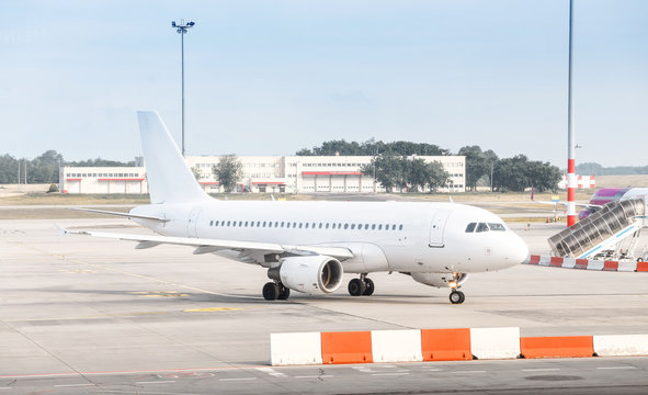 The white plane at the airport taxiway, airline transportation concept