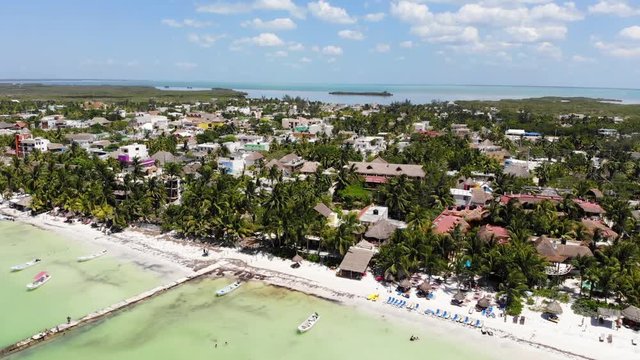 Aerial shot of Isla Holbox beachfront resorts on a sunny day, Mexico