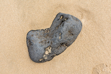 Stone in sand