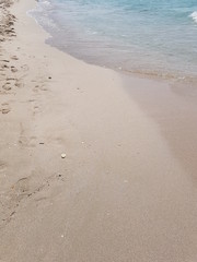 blue clear water and white sand on a sunny day