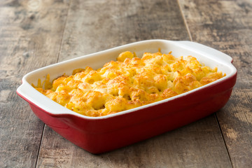 Typical American macaroni and cheese on wooden table