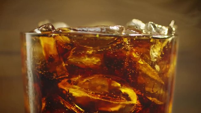 Cold cola with ice cubes