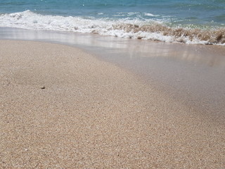 blue clear water and white sand on a sunny day