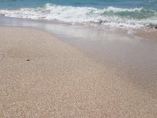 blue clear water and white sand on a sunny day