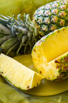 Macro shot of a ripe and sliced pineapple fruit (Ananas comosus).