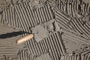 Mortar or tile adhesive at floor or wall with trowel