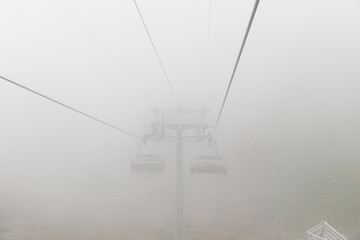 Aibga Ridge. Mountain Kamennyy stolb. 2509m. Mountains near the ski resort. cable car on the mountain going into the fog and clouds