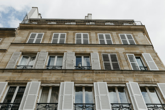 Paris residential buildings. Old Paris architecture, beautiful facades, typical french houses. Famous travel destinations in Europe. Background. City life, lifestyle and expensive real estate concept