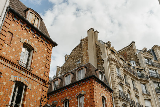Paris residential buildings. Old Paris architecture, beautiful facade, typical french houses on sunny day. Famous travel destinations in Europe. City life, lifestyle and expensive real estate concept