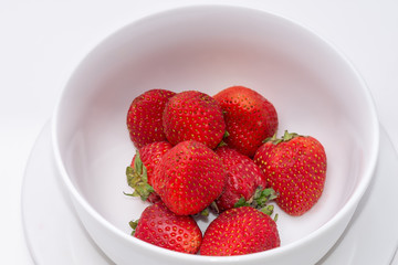 Fresh strawberries in white bowl with room for copy text