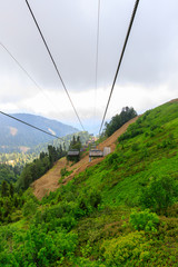 Fototapeta na wymiar Aibga Ridge. Mountain Kamennyy stolb. 2509m. Mountains near the ski resort. cable car on the mountain going into the clouds