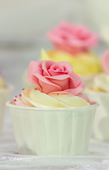 Cupcakes on tier at wedding reception./ Sweet beauty flower and topping pastel color on wedding cake decoration.