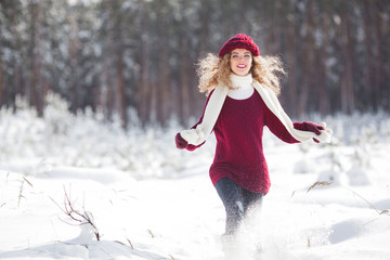 Young beautiful woman having fun in winter time outdoors