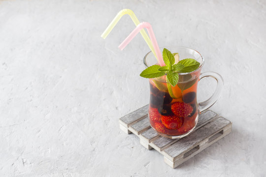Cocktail with black currant, strawberry, mint and lime. Cooling summer drink.