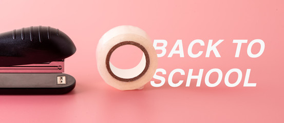 stapler and tape minimal on pink background Back to school Education with copy space with back to school