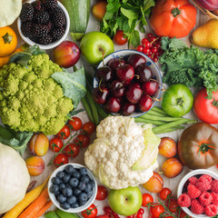 Assortment of healthy fruits vegetables berries, cherries cabbage broccoli cauliflower squash...