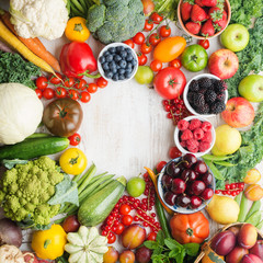 Fresh fruits vegetables berries arranged in a circle frame, cherries peaches strawberries cabbage broccoli cauliflower squash tomatoes carrots beetroot, copy space, top view, aquare selective focus